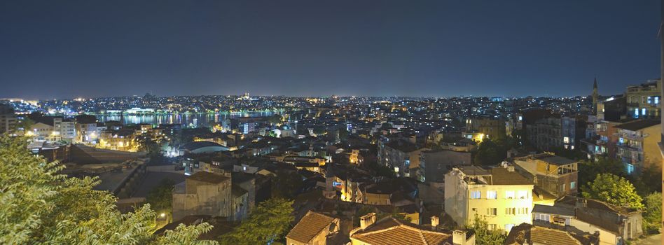 Panoramic view of a city residential area in Istanbul with a river at night