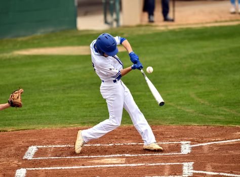 Action photo of high school baseball players making amazing plays during a baseball game