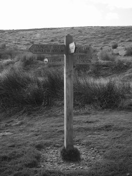Signpost on walking paths shot in black and white near Hole of Horcum and Levisham in North York Moors National Park , Yorkshire, UK