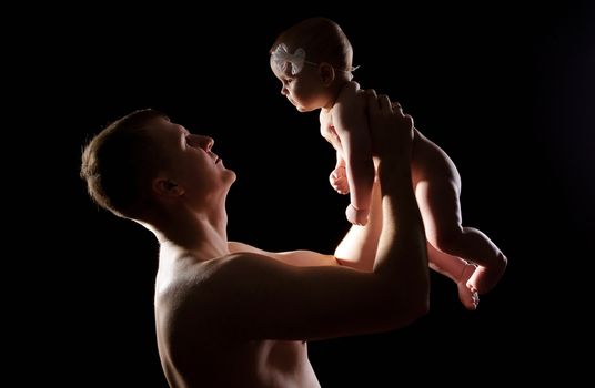 Male holding nice infant baby girl. Daughter on father's arms. Human growth and development. New generation. Cheerful man and his baby. New life concept. Silhouette
