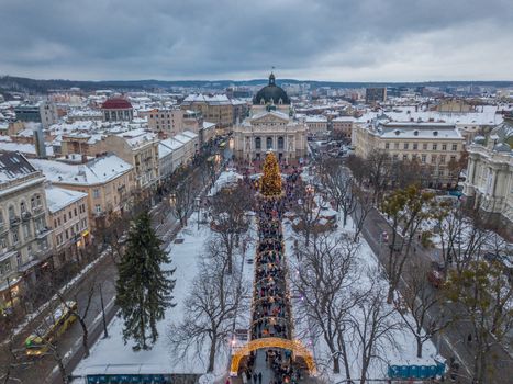 Lviv, Ukraine, December. Arial shot. Lvov Opera house. Christmas tree. Christmas Fair. People are walking around the city center