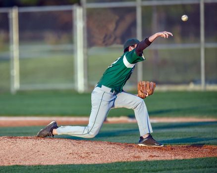 Action photo of high school baseball players making amazing plays during a baseball game