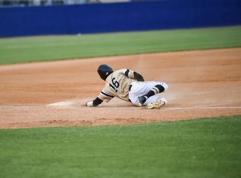 Action photo of high school baseball players making amazing plays during a baseball game