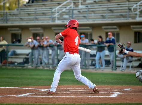 Action photo of high school baseball players making amazing plays during a baseball game