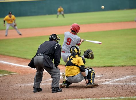 Action photo of high school baseball players making amazing plays during a baseball game