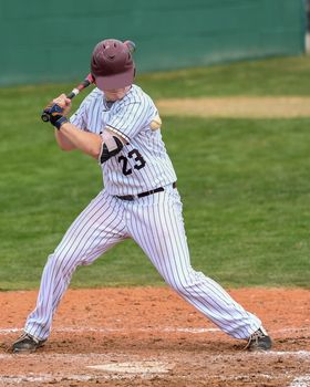 Action photo of high school baseball players making amazing plays during a baseball game