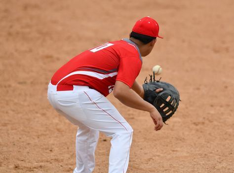 Action photo of high school baseball players making amazing plays during a baseball game