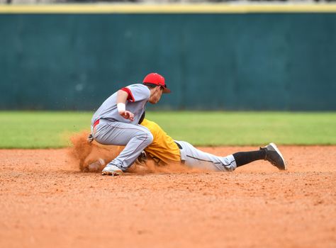 Action photo of high school baseball players making amazing plays during a baseball game