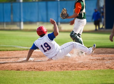 Action photo of high school baseball players making amazing plays during a baseball game