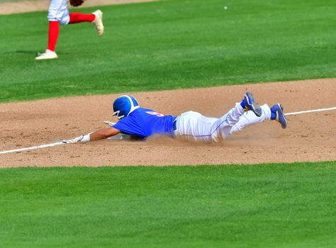 Action photo of high school baseball players making amazing plays during a baseball game