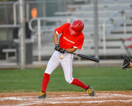 Action photo of high school baseball players making amazing plays during a baseball game