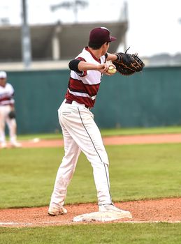 Action photo of high school baseball players making amazing plays during a baseball game