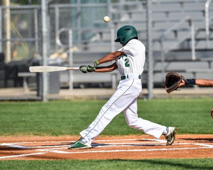 Action photo of high school baseball players making amazing plays during a baseball game