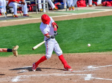 Action photo of high school baseball players making amazing plays during a baseball game