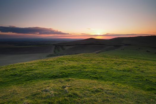 Sunset from the top of Knap Hill looking across the Vale of Pewsey and Salisbury Plain, North Wessex Downs, Wiltshire, UK