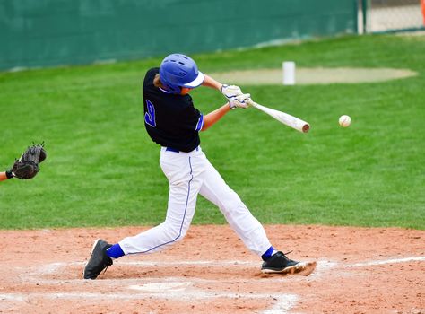 Action photo of high school baseball players making amazing plays during a baseball game