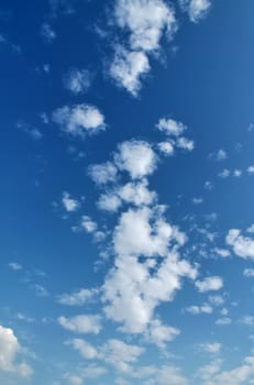 Beautiful fluffy white beautiful cloud formations in a deep blue summer sky