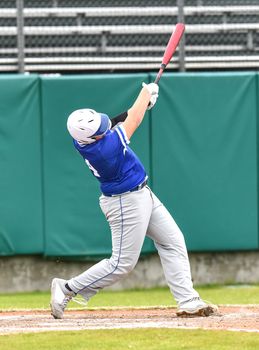 Action photo of high school baseball players making amazing plays during a baseball game