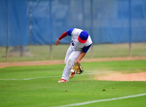 Action photo of high school baseball players making amazing plays during a baseball game