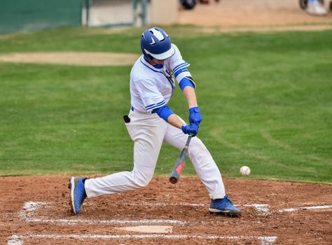 Action photo of high school baseball players making amazing plays during a baseball game