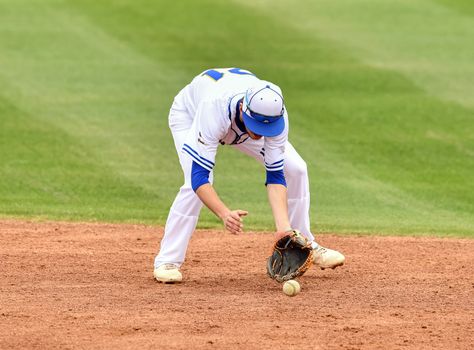 Action photo of high school baseball players making amazing plays during a baseball game