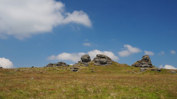 Great Links Tor with white clouds in a blue sky, Dartmoor National Park, Devon, UK