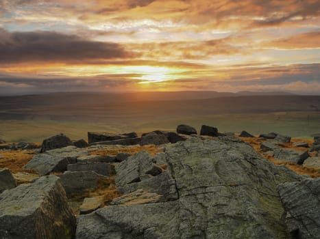 Stunning sunset from the rocky outcrop at the top of Great Whernside overlooking Kettlewell, Wharfedale, Yorkshire Dales, UK