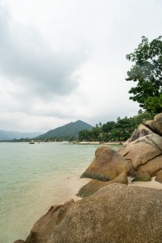 Beach with a rocks in cloudy day on tropical island at South of Thailand