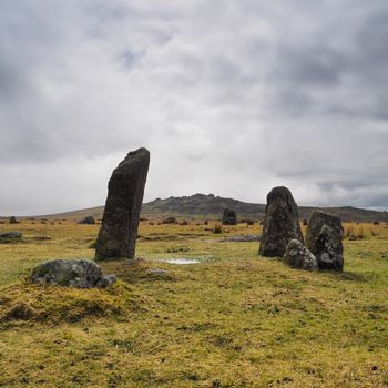 Bronze Age standing Stone Rows at Merrivale Prehistoric site with King's Tor in the background and storm clouds overhead, Dartmoor National Park, Devon, UK