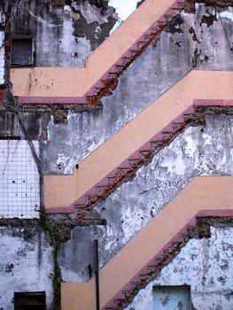 A building with one half torn down showing staircases
