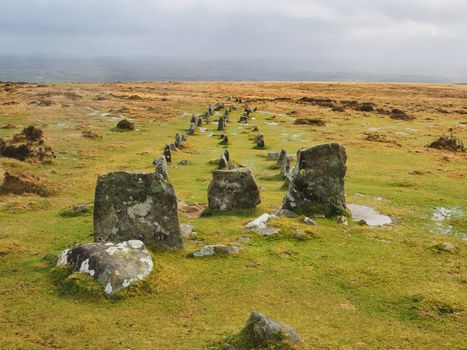 High up on Cosdon Hill multiple stone rows constructed in the Bronze age and known locally as The Graveyard look out over the countryside below, Dartmoor National Park, Devon, UK