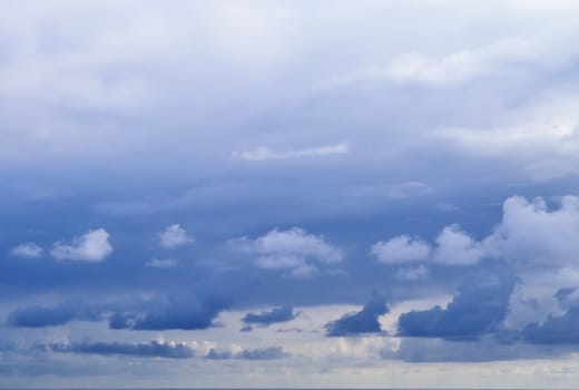 Beautiful fluffy white beautiful cloud formations in a deep blue summer sky