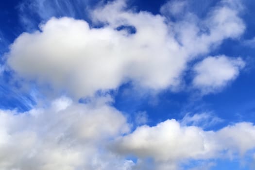 Beautiful fluffy white beautiful cloud formations in a deep blue summer sky