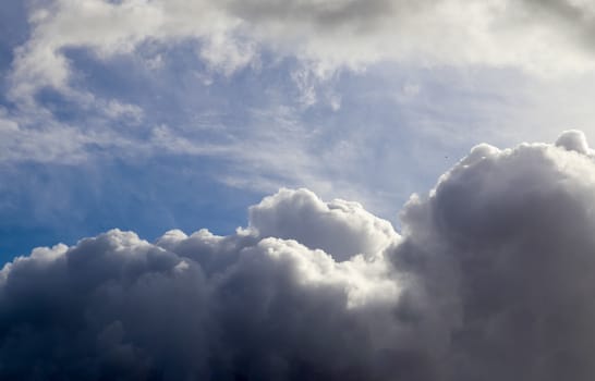 Beautiful fluffy white beautiful cloud formations in a deep blue summer sky