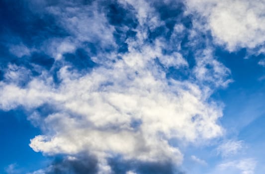 Beautiful fluffy white beautiful cloud formations in a deep blue summer sky