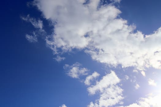 Beautiful fluffy white beautiful cloud formations in a deep blue summer sky