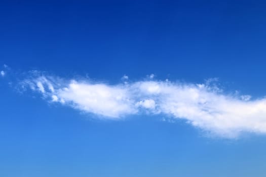 Beautiful fluffy white beautiful cloud formations in a deep blue summer sky