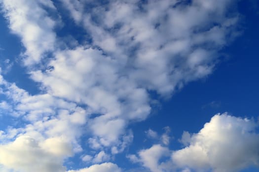 Beautiful fluffy white beautiful cloud formations in a deep blue summer sky