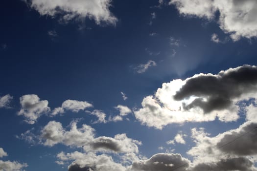 Beautiful fluffy white beautiful cloud formations in a deep blue summer sky