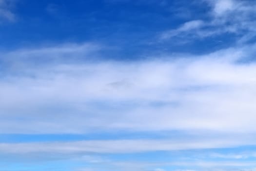 Beautiful fluffy white beautiful cloud formations in a deep blue summer sky