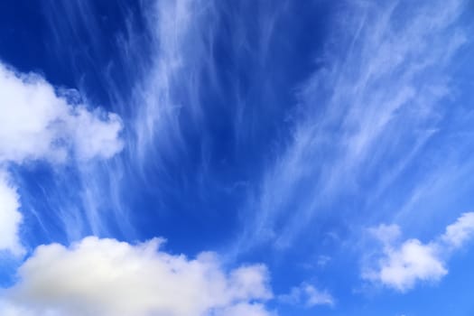 Beautiful fluffy white beautiful cloud formations in a deep blue summer sky