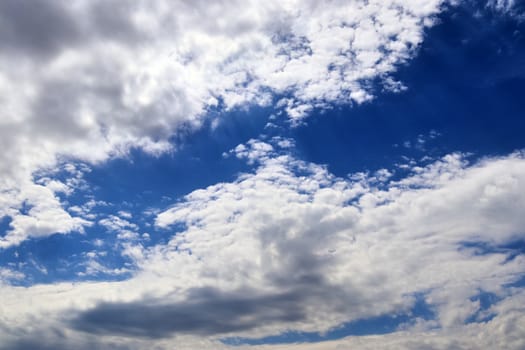 Beautiful fluffy white beautiful cloud formations in a deep blue summer sky