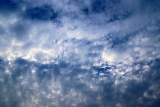 Beautiful fluffy white beautiful cloud formations in a deep blue summer sky