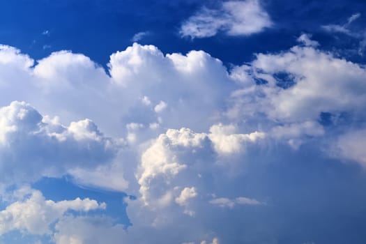 Beautiful fluffy white beautiful cloud formations in a deep blue summer sky