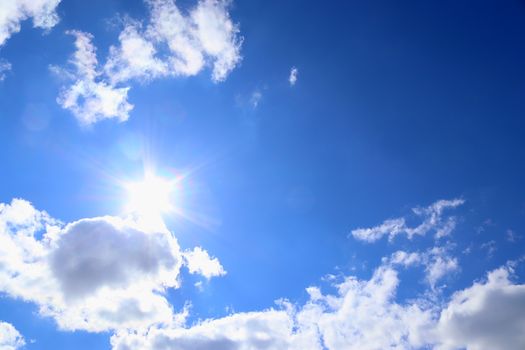 Beautiful fluffy white beautiful cloud formations in a deep blue summer sky