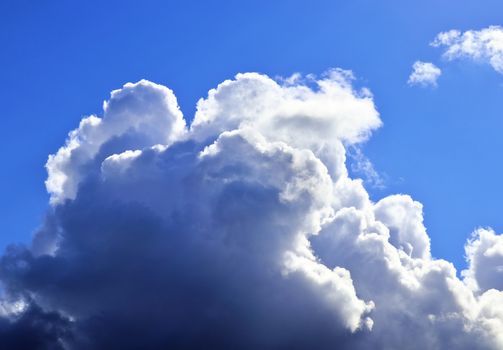 Beautiful fluffy white beautiful cloud formations in a deep blue summer sky