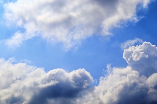 Beautiful fluffy white beautiful cloud formations in a deep blue summer sky