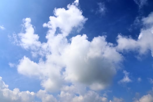 Beautiful fluffy white beautiful cloud formations in a deep blue summer sky