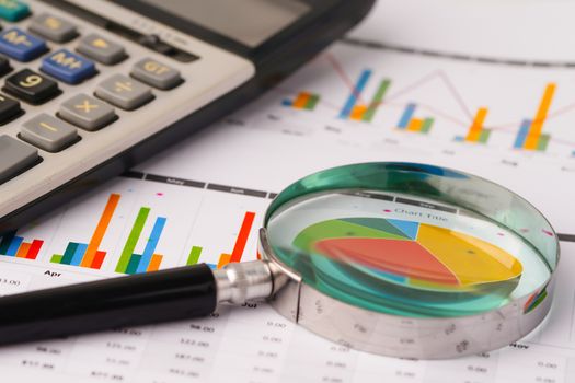 Magnifying glass on charts graphs spreadsheet paper. Financial development, Banking Account, Statistics, Investment Analytic research data economy, Stock exchange trading, Business office company meeting concept.