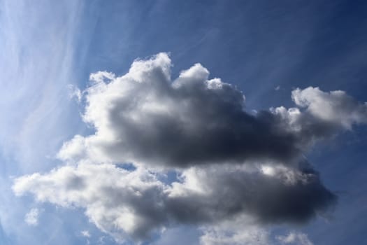 Beautiful fluffy white beautiful cloud formations in a deep blue summer sky